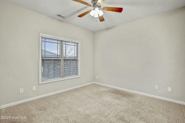 carpeted spare room with ceiling fan