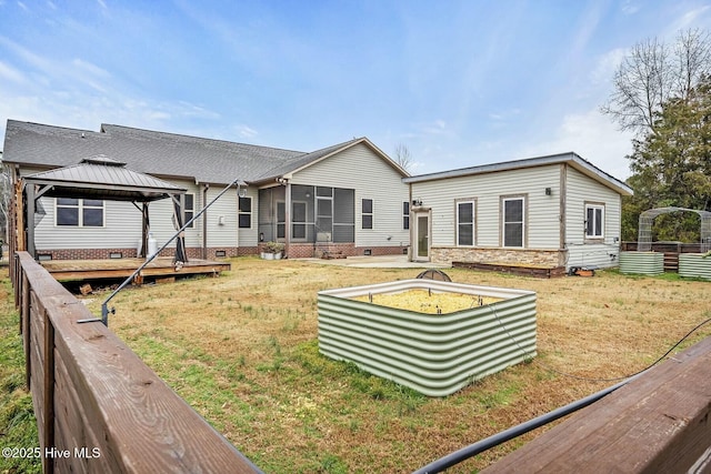 rear view of property featuring a gazebo and a yard