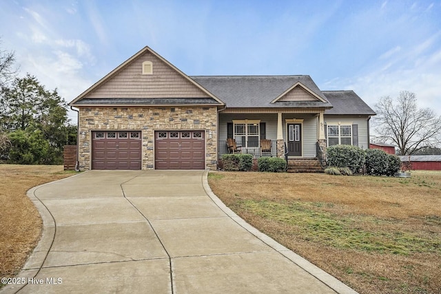 view of front of property featuring a garage, covered porch, and a front yard