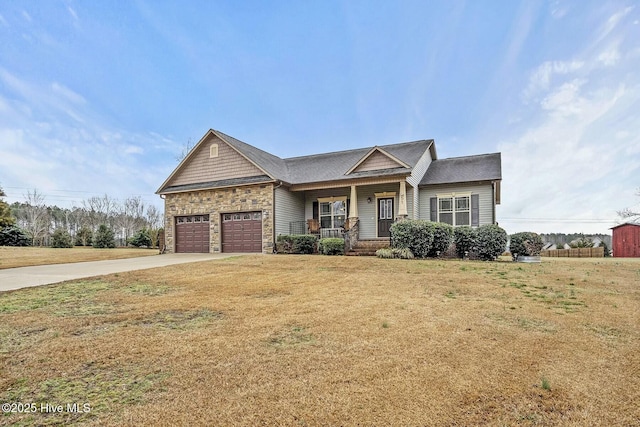 craftsman house with a garage, a front yard, and covered porch