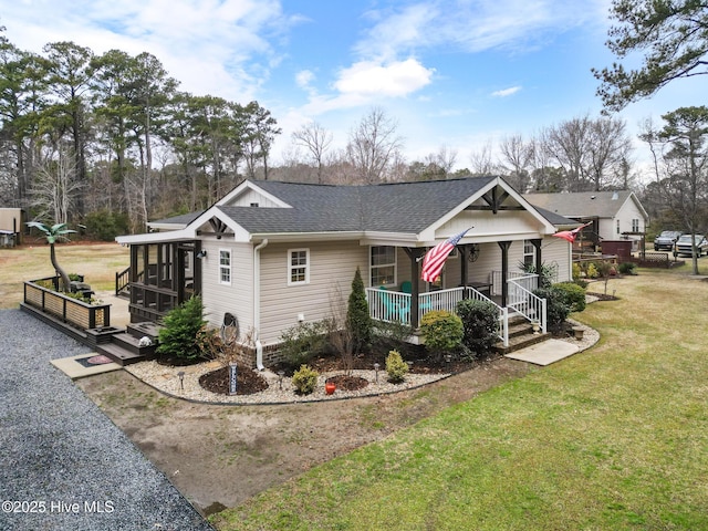 view of front of house featuring covered porch, a front lawn, and a sunroom