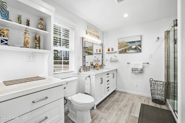 bathroom with a shower with door, wood-type flooring, vanity, and toilet