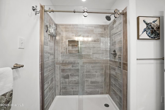 bathroom featuring a shower with door