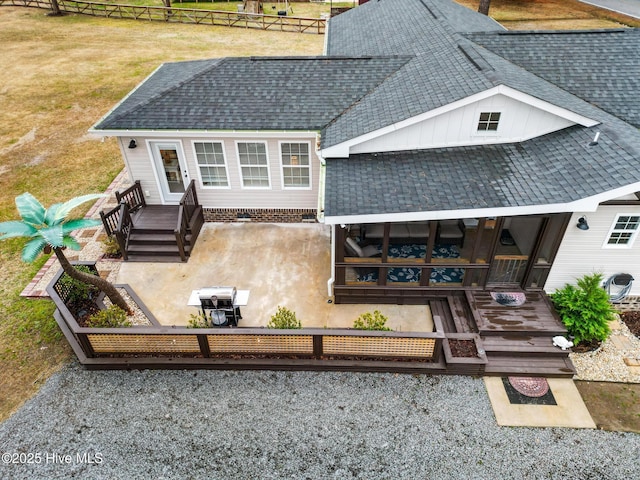 back of property featuring a wooden deck