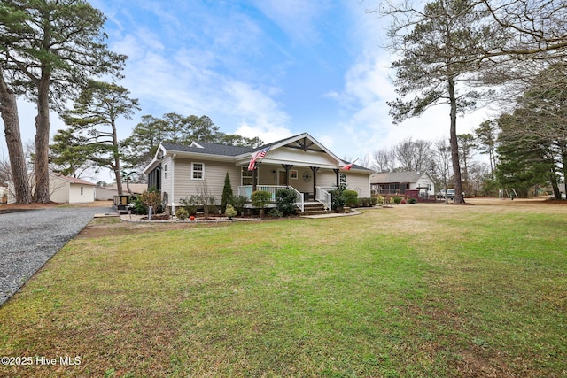 view of front of house with covered porch and a front yard