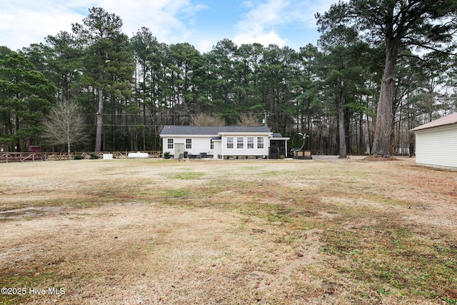 back of house featuring a yard