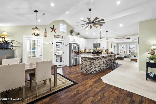 kitchen with white cabinetry, sink, decorative light fixtures, and appliances with stainless steel finishes