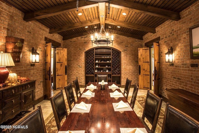 wine area featuring brick wall, an inviting chandelier, and wood finished floors