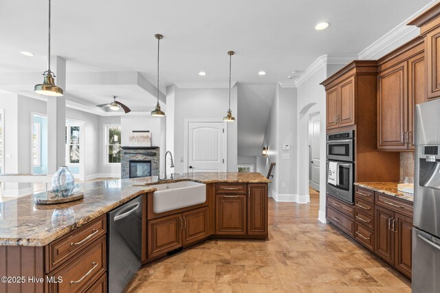 kitchen featuring a sink, light wood-style floors, premium range hood, and stainless steel appliances