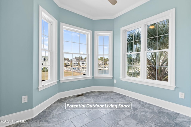 empty room with baseboards, plenty of natural light, and crown molding