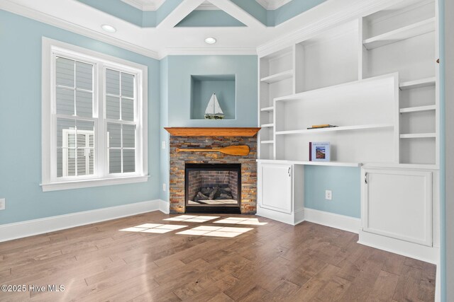 spare room with visible vents, wood finished floors, arched walkways, crown molding, and baseboards