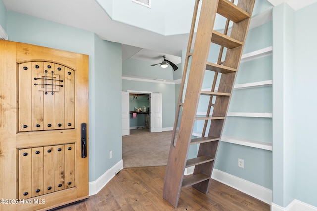 foyer entrance with wood finished floors, baseboards, and ceiling fan