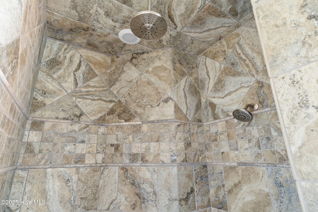 interior details with a tile shower