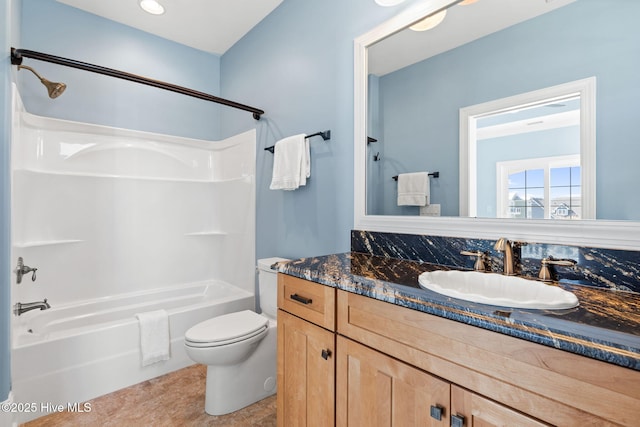 full bath featuring tub / shower combination, toilet, and vanity