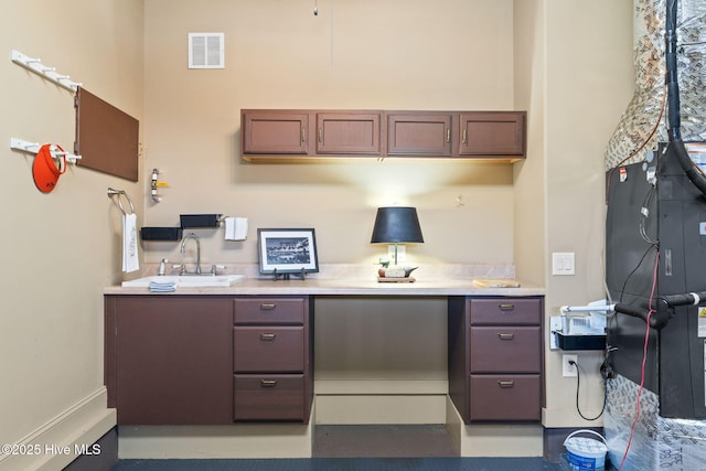 home office featuring visible vents and a sink