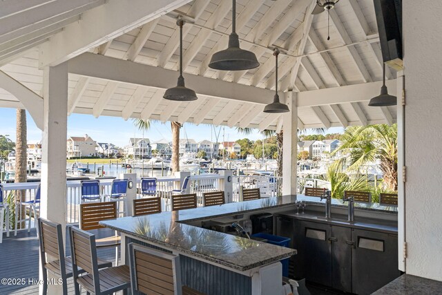 dock area featuring a water view and a residential view