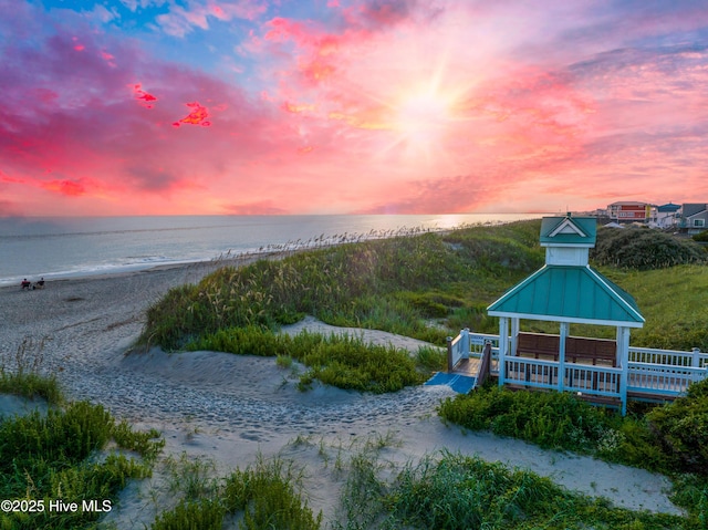 water view with a gazebo and a view of the beach