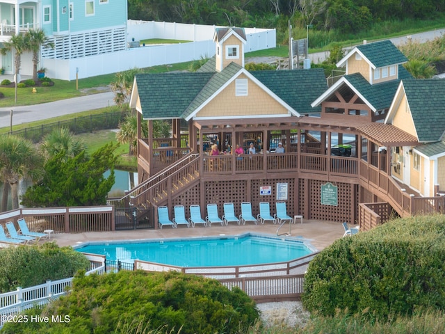 pool with stairway, a patio, and fence