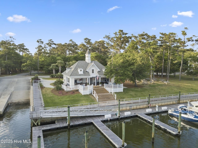 dock area with a deck with water view and a lawn