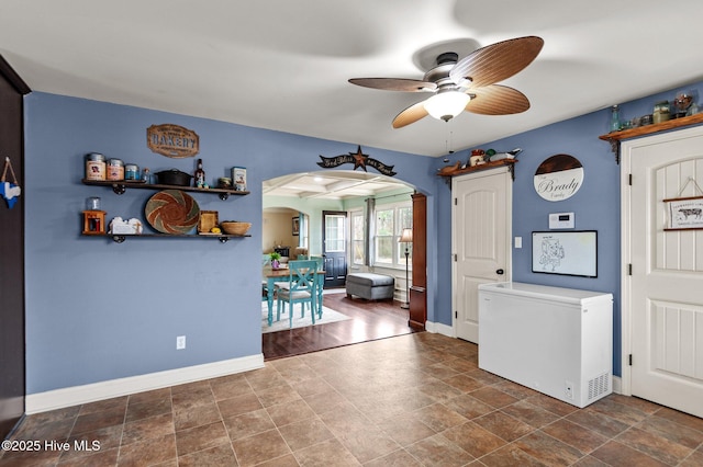 interior space with ceiling fan