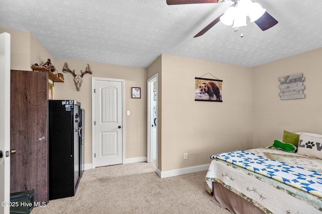 carpeted bedroom with ceiling fan and a textured ceiling