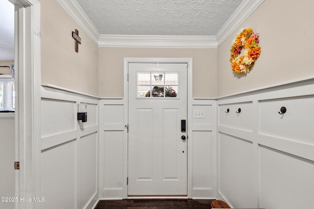 doorway to outside featuring ornamental molding, dark wood-type flooring, and a textured ceiling