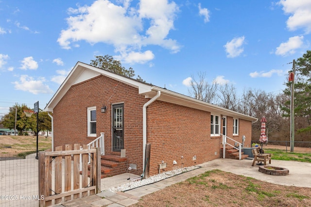 view of side of home with a fire pit