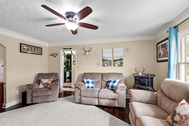 living room featuring hardwood / wood-style flooring, ornamental molding, ceiling fan, and a textured ceiling