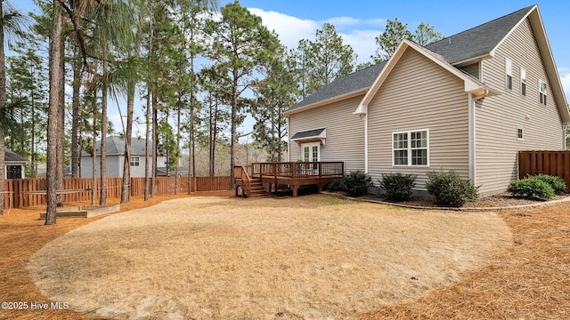 back of property with a wooden deck