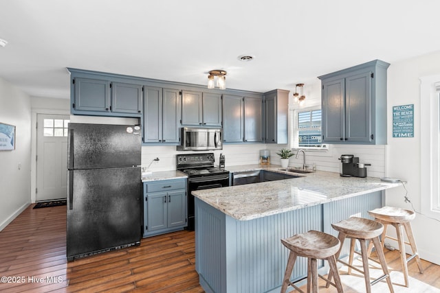 kitchen with a healthy amount of sunlight, black appliances, visible vents, and a sink