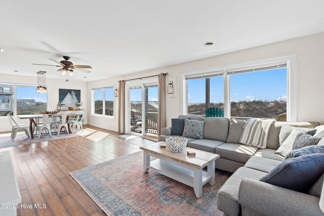 living room with wood finished floors and a ceiling fan