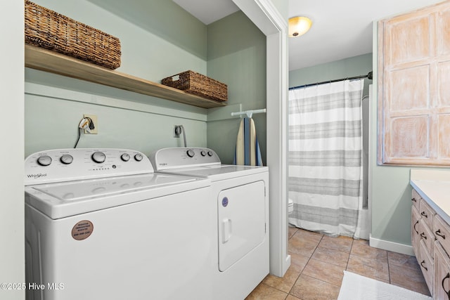 laundry area with laundry area, baseboards, separate washer and dryer, and light tile patterned flooring