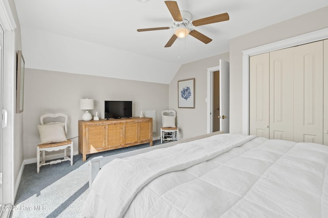 bedroom with lofted ceiling, carpet, a ceiling fan, and a closet