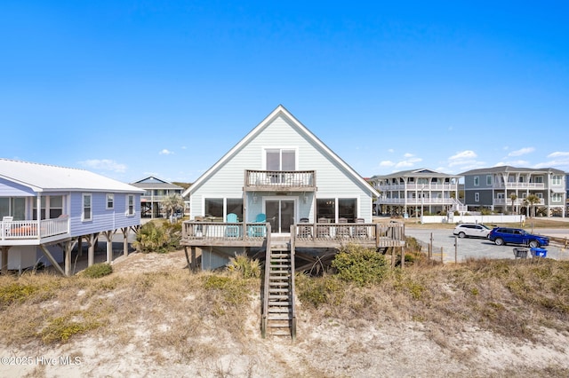 back of property with stairs, a deck, and a balcony