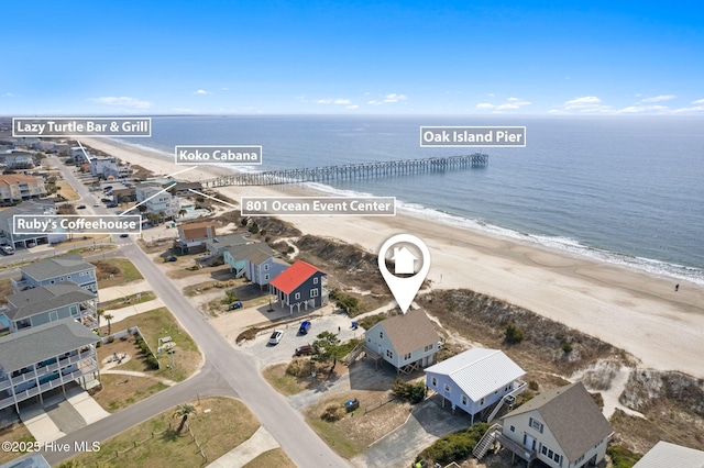 bird's eye view featuring a view of the beach, a water view, and a residential view