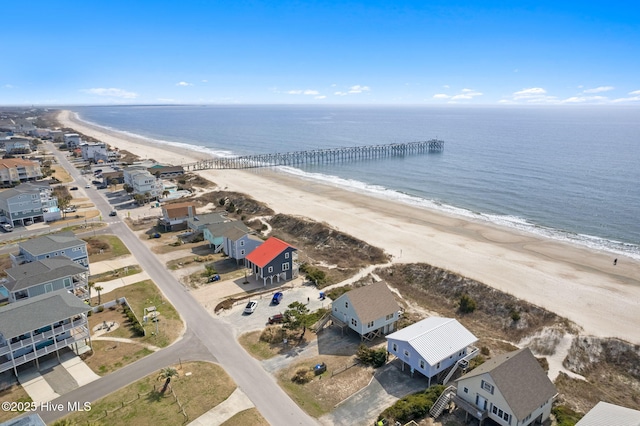 drone / aerial view featuring a beach view and a water view