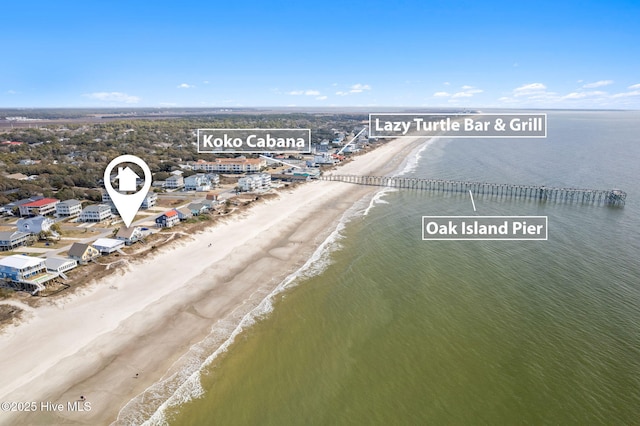 birds eye view of property with a beach view and a water view