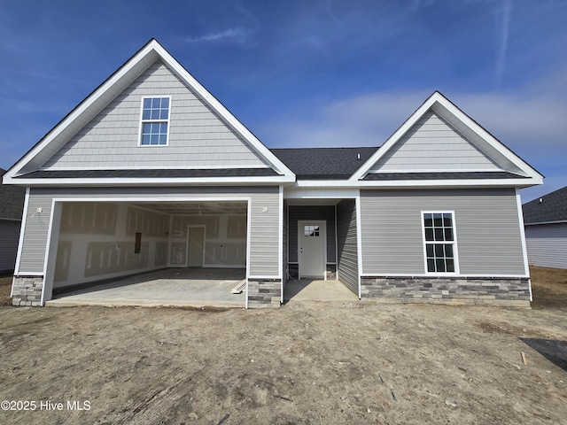 view of front of home featuring a garage and a patio