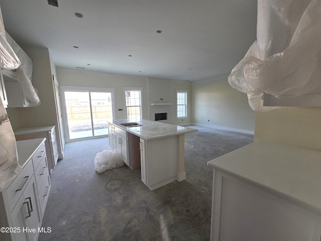 kitchen featuring cooktop, white cabinetry, and a kitchen island