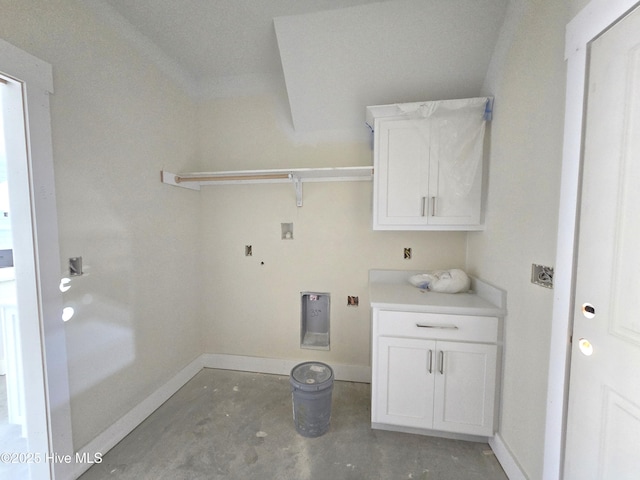 clothes washing area featuring hookup for a washing machine and cabinets