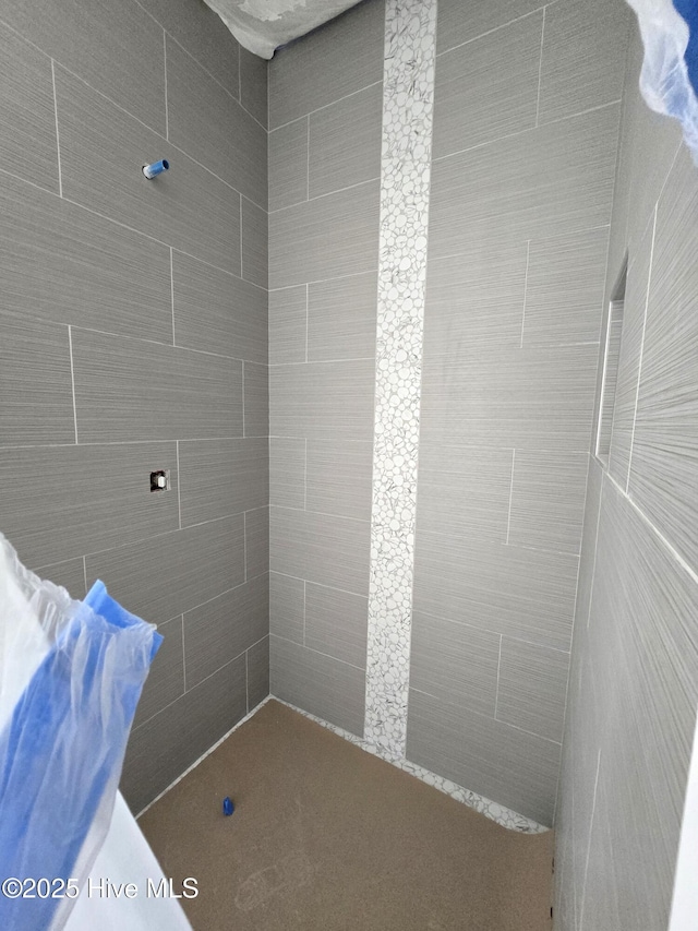 bathroom with tiled shower