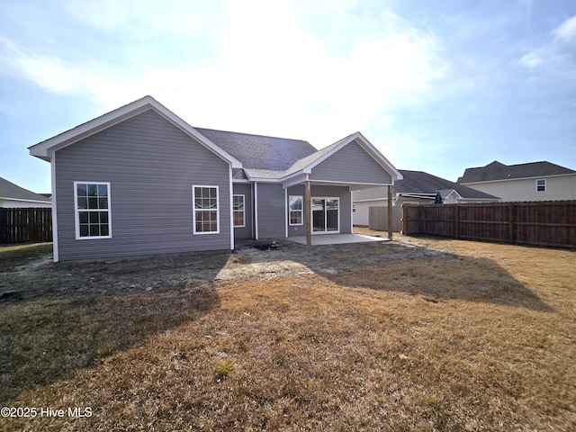 back of property featuring a patio and a yard