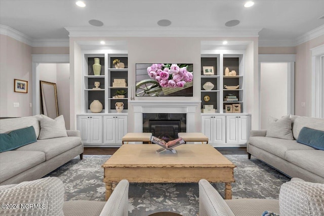 living room with dark wood-type flooring, recessed lighting, a glass covered fireplace, and crown molding