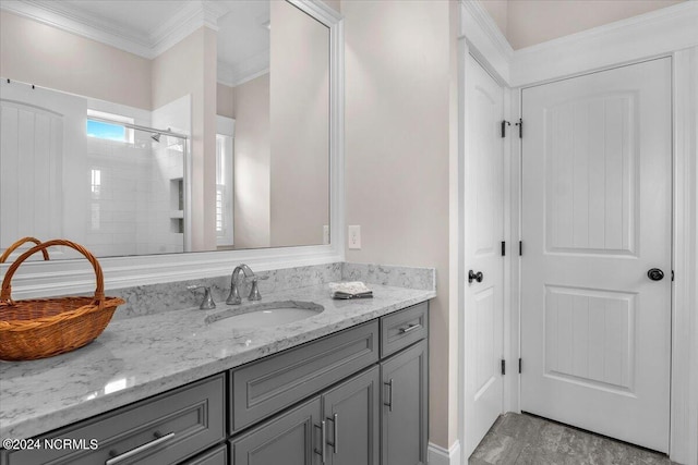 full bath featuring ornamental molding, a shower stall, and vanity