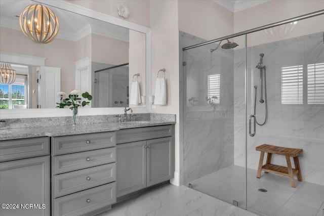 bathroom with a notable chandelier, vanity, marble finish floor, ornamental molding, and a marble finish shower