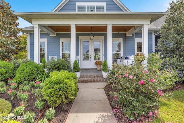 view of exterior entry with a porch