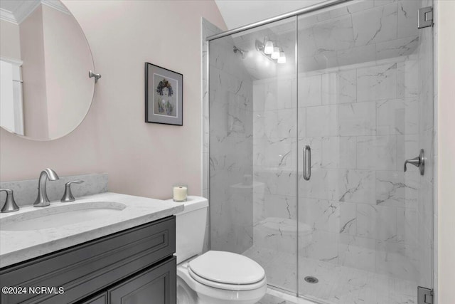 full bathroom featuring toilet, a marble finish shower, and vanity