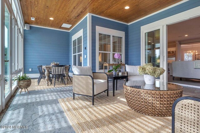 sunroom with wooden ceiling and a ceiling fan