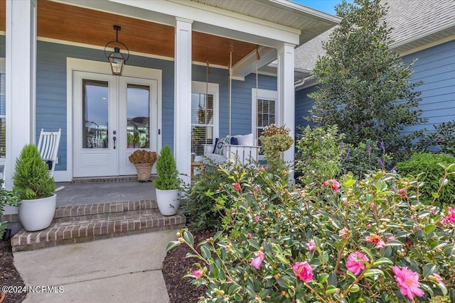 property entrance with a porch and french doors