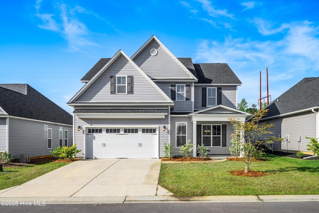 view of front property featuring a garage and a front lawn